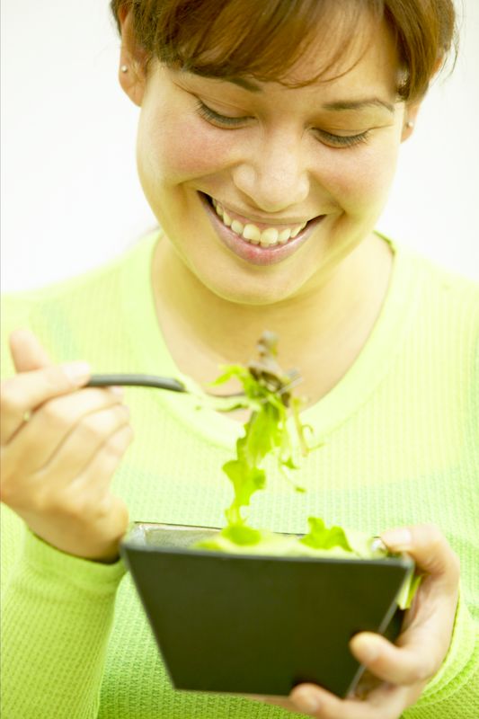 Lady in Green eating Salad St. Patrick's Day